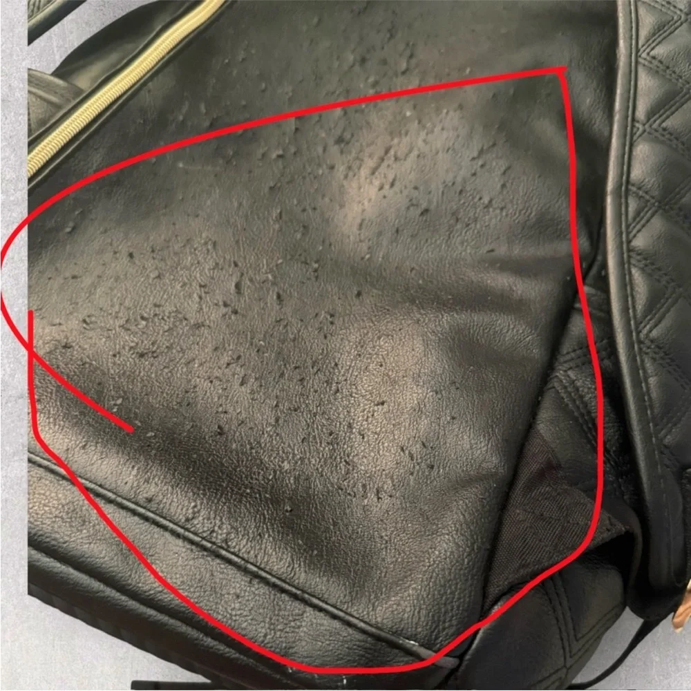 Itzy Ritzy Boss Plus black diaper bag backpack with gold hardware.